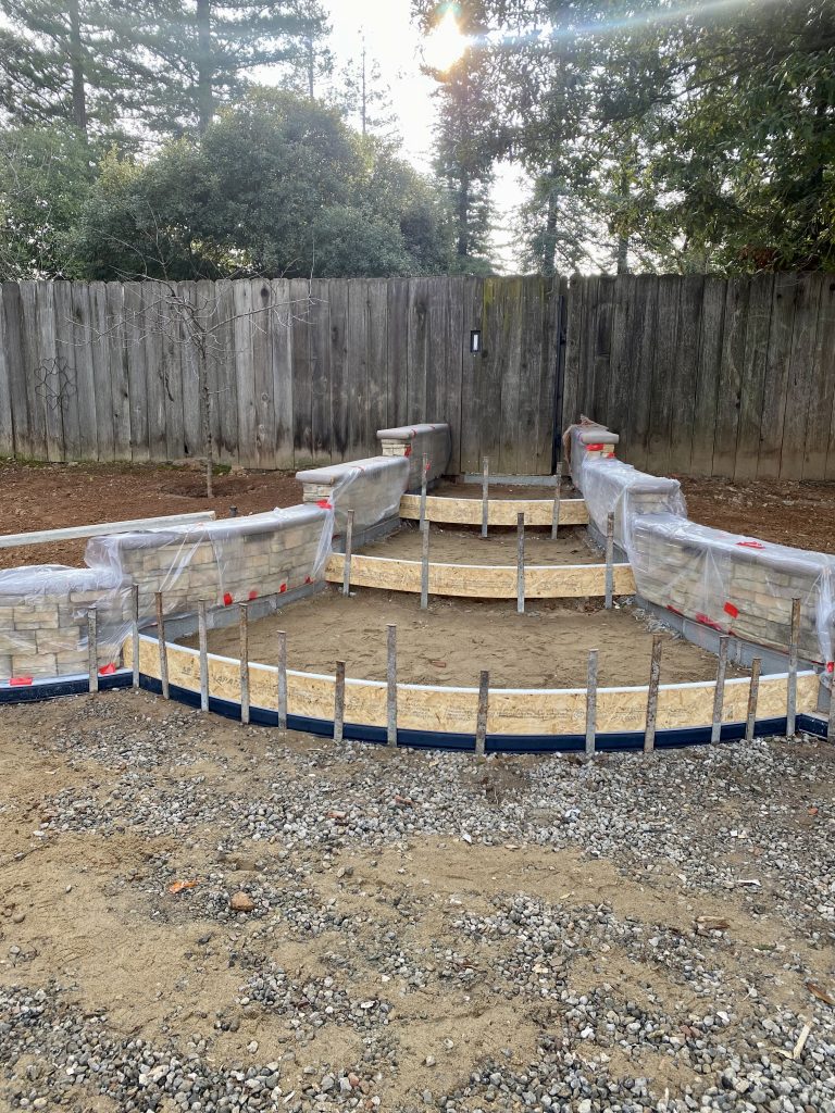 Curved concrete forms installed and finished walls are draped before pouring concrete in the Wedemeyer backyard renovation by Sunset Construction.